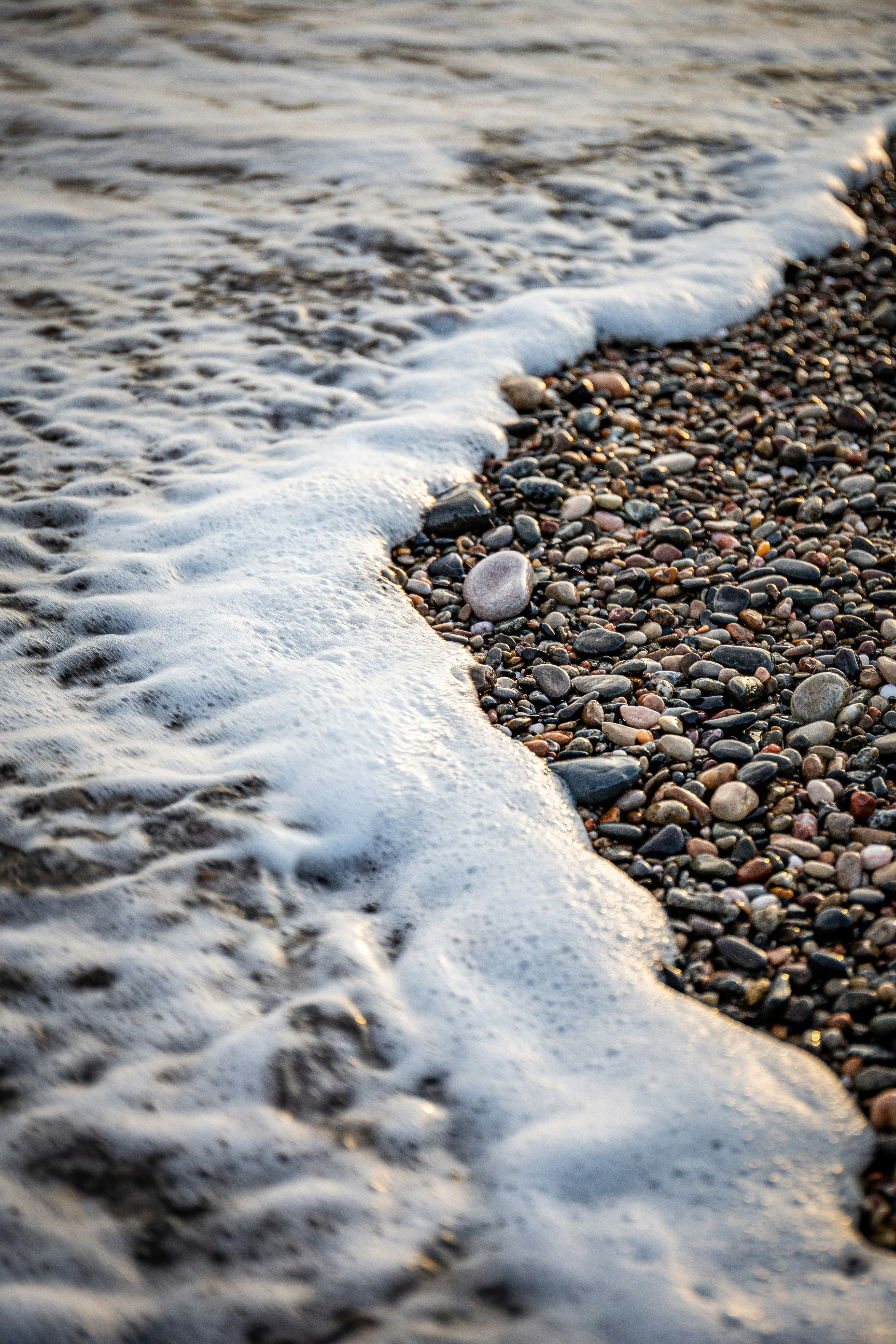 brown and black stones on seashore during daytime